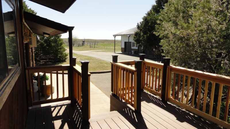 Steps at back of house off deck going to covered patio 